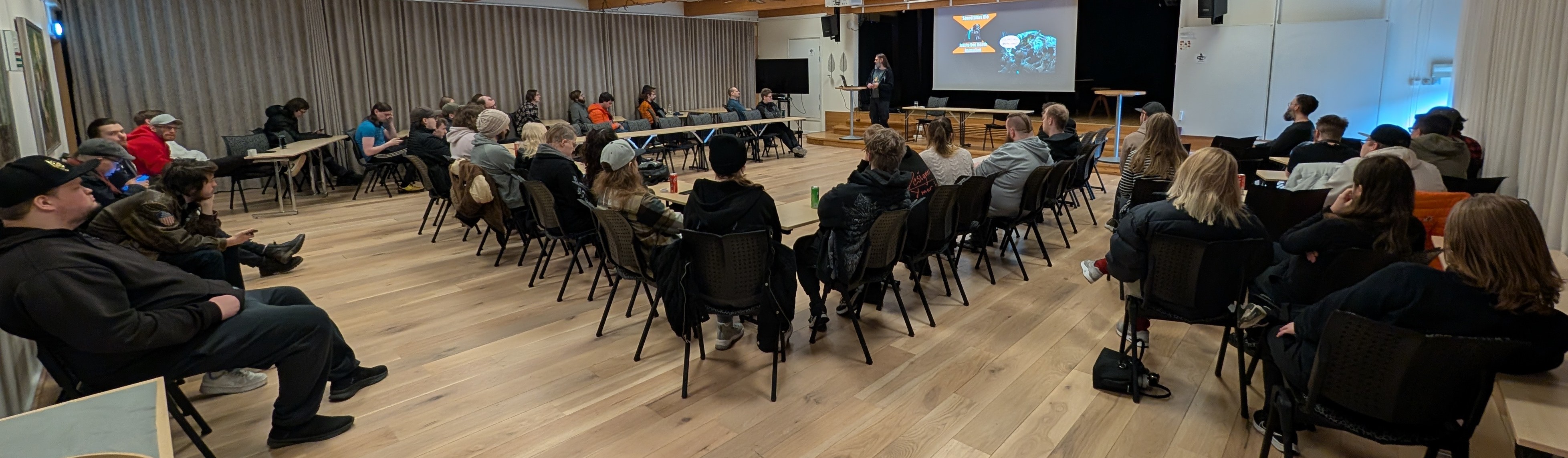 A workshop group discussion in progress, participants seated in a circle