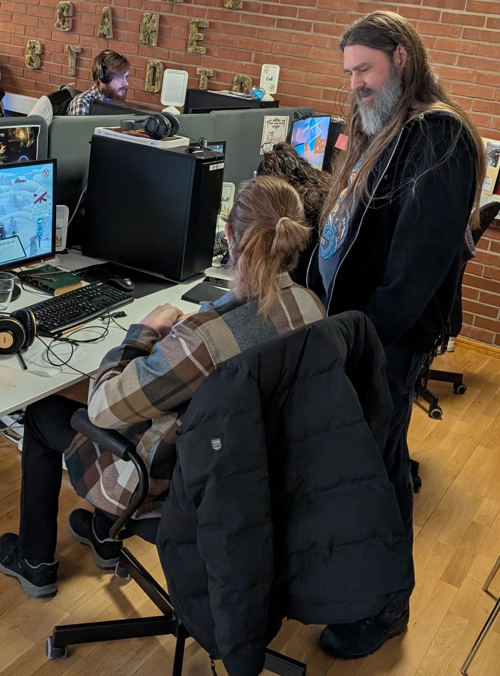 Brian Bartram in conversation with a game developer during a consulting session