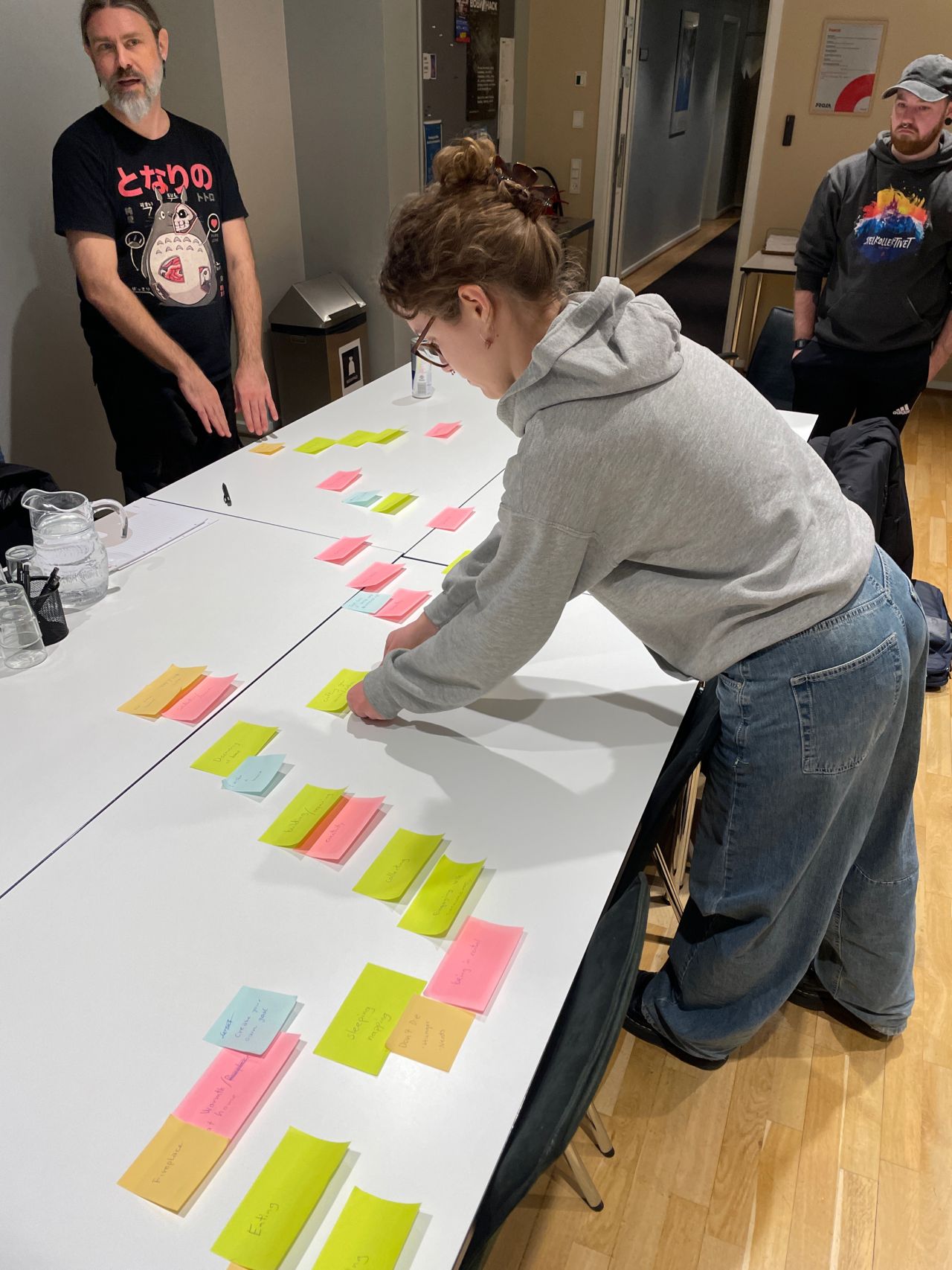 Participants sketching game mechanics on paper during a game design fundamentals workshop